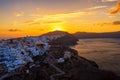 Aerial drone view of famous Oia village with white houses and blue dome churches during sunrise on Santorini island, Aegean sea, Royalty Free Stock Photo