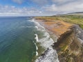 Aerial drone view on Fanore beach, county Clare, Ireland. Warm sunny day, People on the beach and surfing in the water.