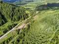 Aerial drone view, forest road near small flooded mountain river Royalty Free Stock Photo