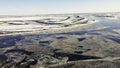Aerial drone view of frozen lakes in a bog in winter. Clip. Endless snow covered fields and swamps. Royalty Free Stock Photo