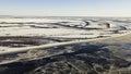 Aerial drone view of frozen lakes in a bog in winter. Clip. Endless snow covered fields and swamps. Royalty Free Stock Photo