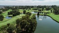 Aerial drone view Golf course fairway, water hazards, fountain, green with sand bunkers surrounded by trees Royalty Free Stock Photo