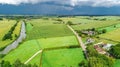 Aerial drone view of green fields and farm houses near canal, typical Dutch landscape, Holland, Netherlands Royalty Free Stock Photo