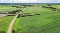 Aerial drone view of green fields and farm houses near canal from above, typical Dutch landscape, Holland, Netherlands Royalty Free Stock Photo