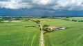 Aerial drone view of green fields and farm houses near canal, typical Dutch landscape, Holland, Netherlands