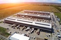 Aerial drone view of group of large modern industrial warehouse or factory buildings in suburban city area.Logistic transportation