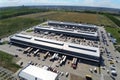 Aerial drone view of group of large modern industrial warehouse or factory buildings in suburban city area.Logistic Royalty Free Stock Photo