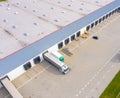 Aerial drone view of group of large modern industrial warehouse or factory buildings in suburban city area.Logistic transportation Royalty Free Stock Photo