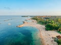 Aerial drone view of Holiday In Sanur Beach, Bali, Indonesia with ocean, boats, beach, villas, and people