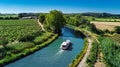 Aerial drone view of houseboat in Canal du Midi from above, family travel by boat, vacation in France Royalty Free Stock Photo