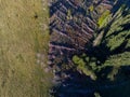 Aerial drone view, huge deforestated area near green pasture in Romania