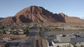 Aerial Drone view of Ivins St George in Utah on a bright sunny winter day showing city in front of red mountains and red cliff nat