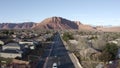 Aerial Drone view of Ivins St George in Utah on a bright sunny winter day showing city in front of red mountains and red cliff nat