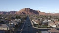 Aerial Drone view of Ivins St George in Utah on a bright sunny winter day showing city in front of red mountains and red cliff nat