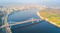 Aerial drone view of Kyiv cityscape and Dnieper river, autumn pedestrian Park bridge, yellow fall trees, Truhaniv island