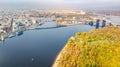 Aerial drone view of Kyiv cityscape and Dnieper river, autumn pedestrian Park bridge, yellow fall trees, Truhaniv island