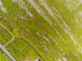 Aerial drone view on land in Burren, county Clare, near Fanore beach, Green grass field with stone patches