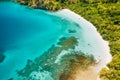 Aerial drone view of lonely boat at beautiful deserted tropical beach and blue lagoon surrounded by lush green jungle Royalty Free Stock Photo