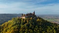 Aerial drone view of medieval Hohenzollern castle on top of hill in autumn, Baden-Wurttemberg, Germany. Royalty Free Stock Photo