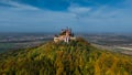 Aerial drone view of medieval Hohenzollern castle on top of hill in autumn, Baden-Wurttemberg, Germany. Royalty Free Stock Photo