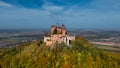 Aerial drone view of medieval Hohenzollern castle on top of hill in autumn, Baden-Wurttemberg, Germany. Royalty Free Stock Photo