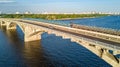 Aerial drone view of Metro railway bridge with train and Dnieper river from above, skyline of city of Kiev, Ukraine