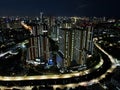 Aerial drone view of modern apartment building in Jakarta central business district at night with Jakarta cityscape. JAKARTA, Royalty Free Stock Photo