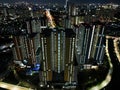 Aerial drone view of modern apartment building in Jakarta central business district at night with Jakarta cityscape. JAKARTA, Royalty Free Stock Photo