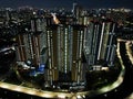 Aerial drone view of modern apartment building in Jakarta central business district at night with Jakarta cityscape. JAKARTA, Royalty Free Stock Photo