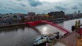 Aerial drone view of modern footbridge Python Bridge at Eastern Docklands neighborhood of Amsterdam Netherlands Royalty Free Stock Photo