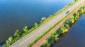 Aerial drone view of motorway road and cycling path on polder dam, cars traffic from above, North Holland, Netherlands