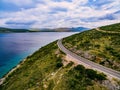 Aerial view of mountain road near the turquoise sea in summer Croatia. Royalty Free Stock Photo