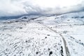 aerial drone view of a mountain road in a snowy landscape. Winter concept Royalty Free Stock Photo