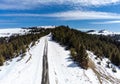 Aerial drone view, narrow asphalt road leading to the top of the mountain at springtime