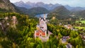 Aerial drone view Neuschwanstein castle on Alps background in vicinity of Munich, Bavaria, Germany, Europe. Autumn