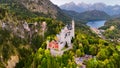 Aerial drone view Neuschwanstein castle on Alps background in vicinity of Munich, Bavaria, Germany, Europe. Autumn