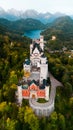 Aerial drone view Neuschwanstein castle on Alps background in vicinity of Munich, Bavaria, Germany, Europe. Autumn