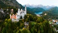 Aerial drone view Neuschwanstein castle on Alps background in vicinity of Munich, Bavaria, Germany, Europe. Autumn