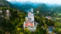 Aerial drone view Neuschwanstein castle on Alps background in vicinity of Munich, Bavaria, Germany, Europe. Autumn