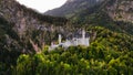 Aerial drone view Neuschwanstein castle on Alps background in vicinity of Munich, Bavaria, Germany, Europe. Autumn Royalty Free Stock Photo