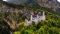 Aerial drone view Neuschwanstein castle on Alps background in vicinity of Munich, Bavaria, Germany, Europe. Autumn