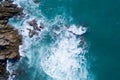 Aerial view of ocean`s beautiful waves and rocky coast