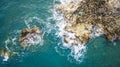 Aerial drone view of the ocean and waves crashing on rocks. Royalty Free Stock Photo