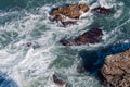 Aerial drone view of the ocean and waves crashing on rocks. Royalty Free Stock Photo