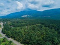 Aerial drone view of oil palm plantations with Ledang Mountain background in Asahan, Melaka, Malaysia.