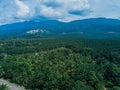 Aerial drone view of oil palm plantations with Ledang Mountain background in Asahan, Melaka, Malaysia.