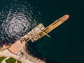 Aerial Drone View of Old Garbage Scow Vessel Ship with Crane in the Port. Royalty Free Stock Photo