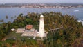 Aerial drone view of the old lighthouse of white stone located on the island