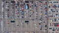 Aerial drone view of parking lot with many cars from above, city transportation