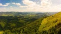 Aerial drone view of picturesque nature with green coniferous forests on the slopes of the mountains in beautiful sunny day Royalty Free Stock Photo